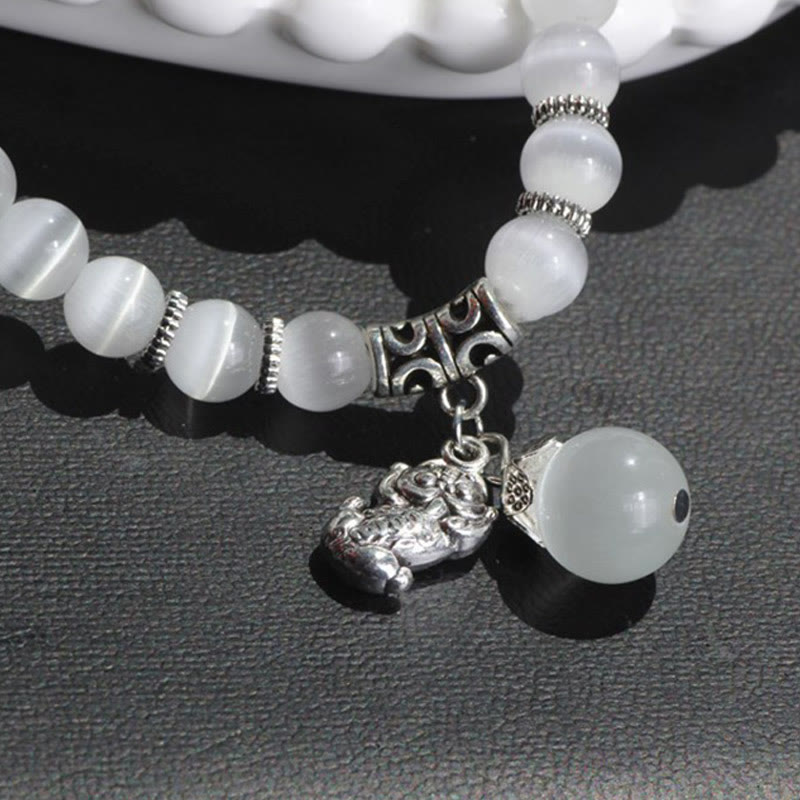 Weißes Katzenauge Armband mit PiXiu Anhänger Charm elegant.