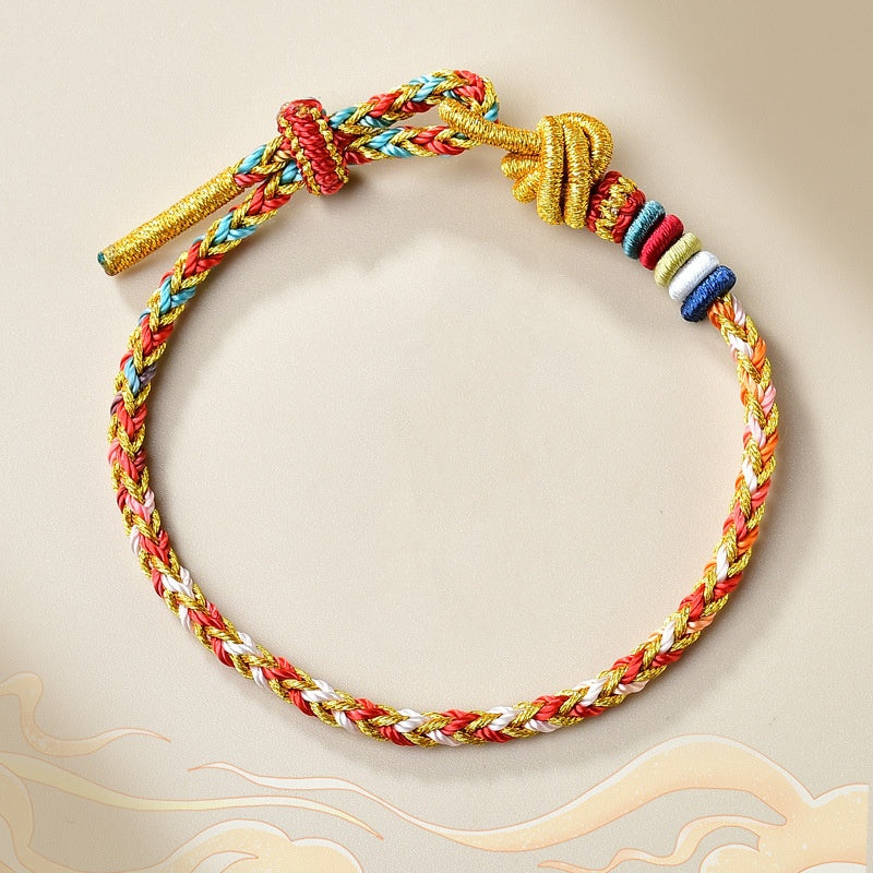 Geflochtenes Armband Gold – Heilung mit bunten Fäden und Perlen.