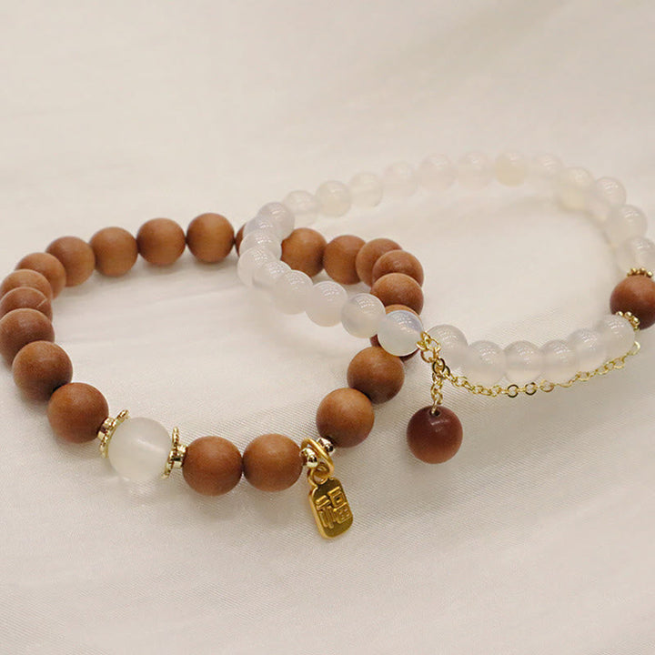 Armband Sandelholz Fu-Zeichen Schutz Mondstein golden elastisch elegant