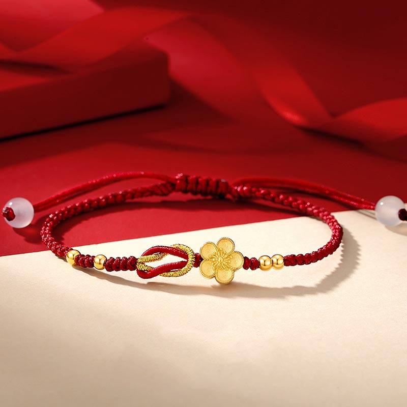 Rotes Armband mit goldenem Blumen-Charm elastisch Glück