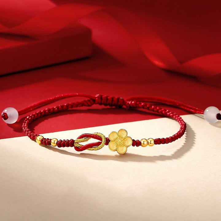 Rotes Armband mit goldenem Blumen-Charm elastisch Glück