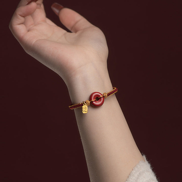 Armband Zinnober Fu-Zeichen Frieden Segen goldene Perlen Handgelenk getragen