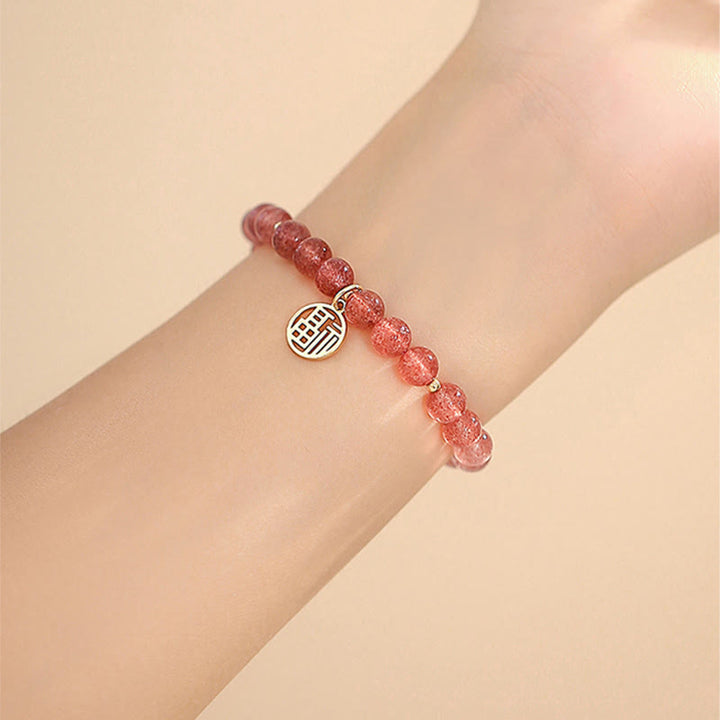 Armband Erdbeerquarz Fu-Zeichen Heilung rosafarbene Perlen Handgelenk