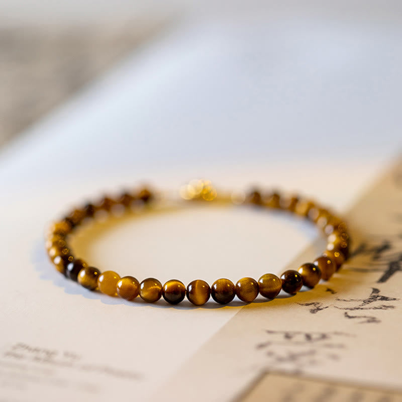 Tigerauge Armband Schutz Mut goldbraune Perlen Naturstein flach gelegt