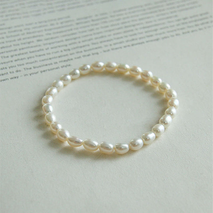 Armband Perle – Heilung, elastisches Perlenarmband mit weißen Naturperlen