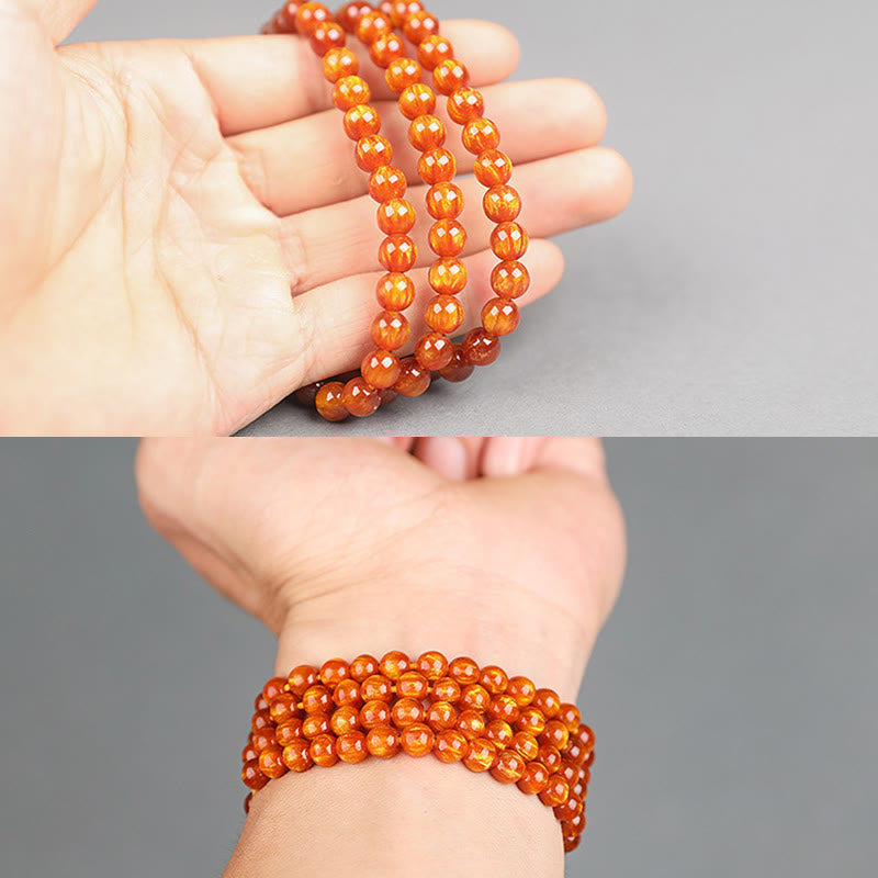 Mala – Erfolg orange Perlen Armband elastisch am Handgelenk getragen