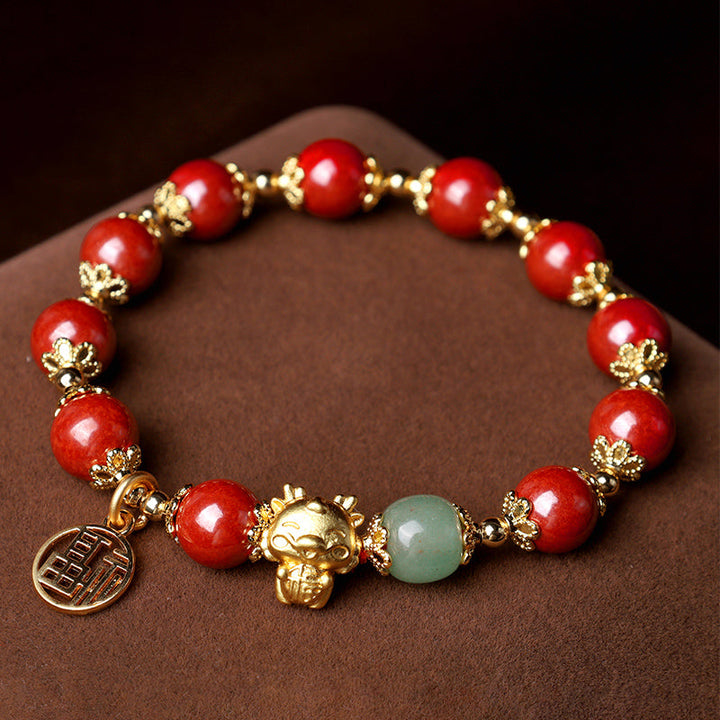 Armband Zinnober Fu-Zeichen goldene Perlen grüner Jade Stein elegant