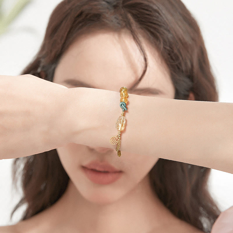 Citrin Armband mit Fu-Zeichen Wohlstand Symbol golden glänzend Handgelenk