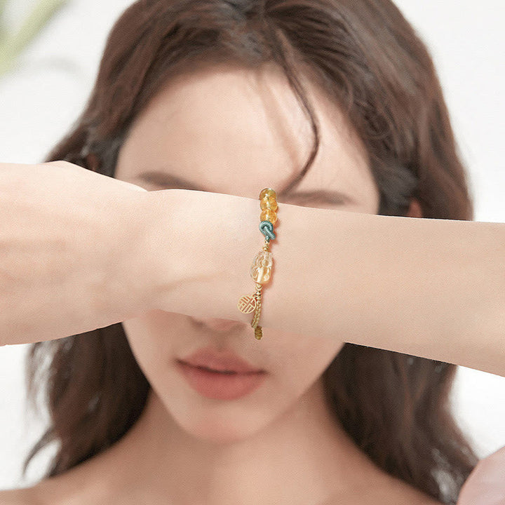 Citrin Armband mit Fu-Zeichen Wohlstand Symbol golden glänzend Handgelenk