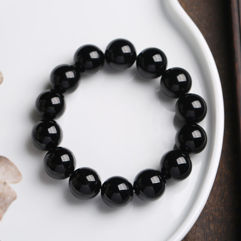 Armband Schwarzer Onyx – Glück mit glänzenden Perlen elegant präsentiert