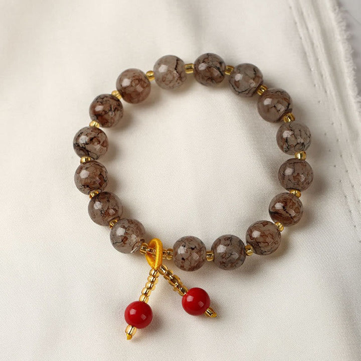 Armband – Harmonie & Segen braun rote Perlen Naturstein elastisch
