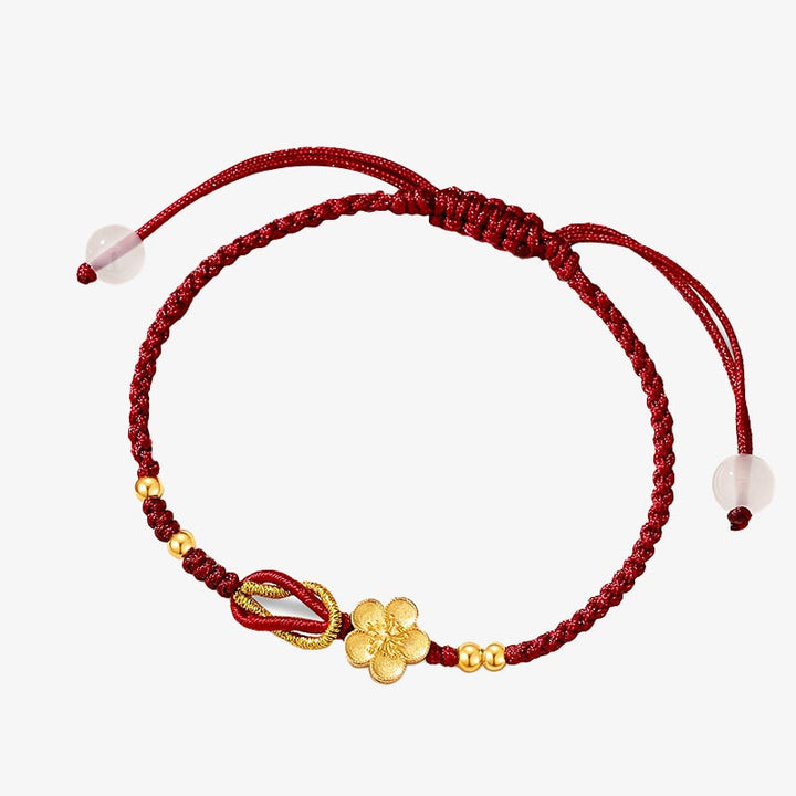 Rotes Armband mit goldenen Glücksanhängern und Rosenquarz Perlen elastisch.