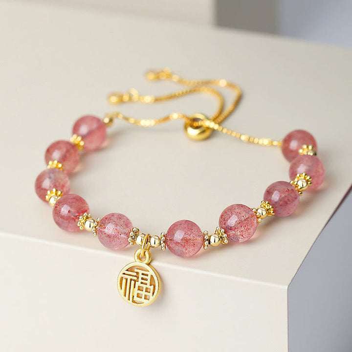 Armband Erdbeerquarz Fu-Zeichen – Energie, rosa Perlen Goldakzente