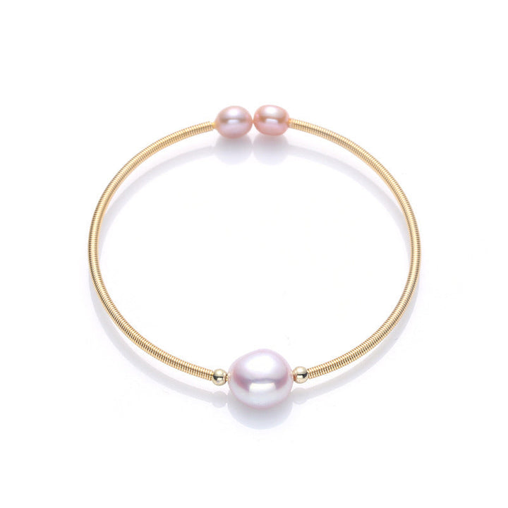 Armband Perle – Wohlstand mit rosa Perlen Goldfeder elegant glänzend.