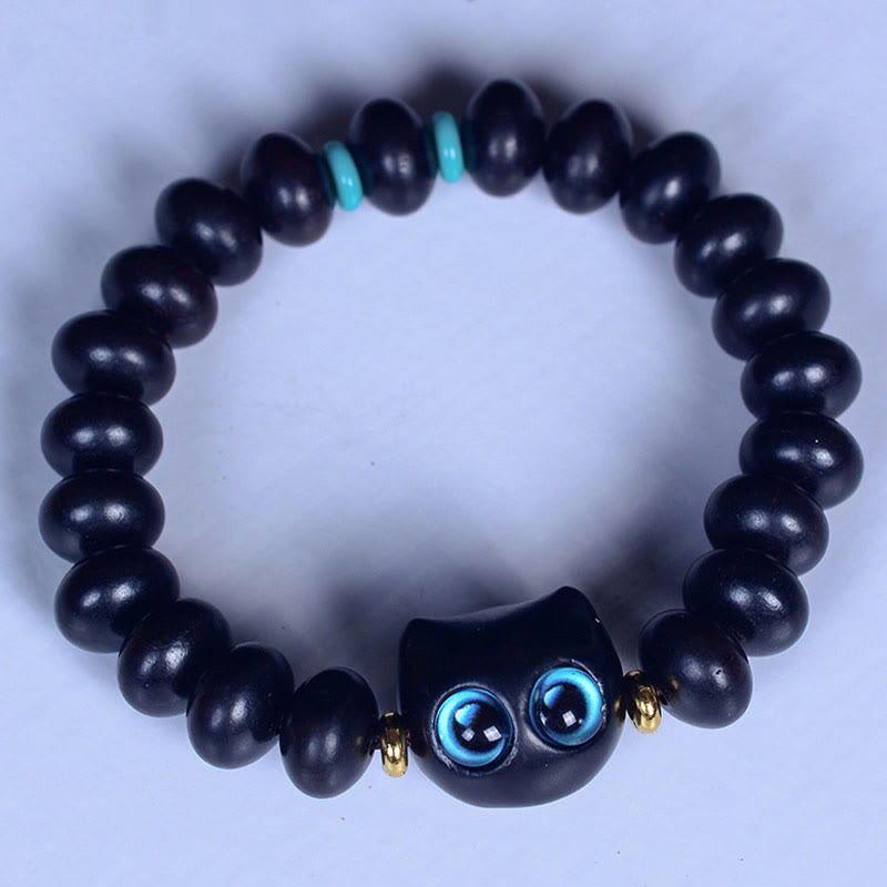 Armband Ebenholz Katze schwarze Perlen blaue Augen elastisch getragen