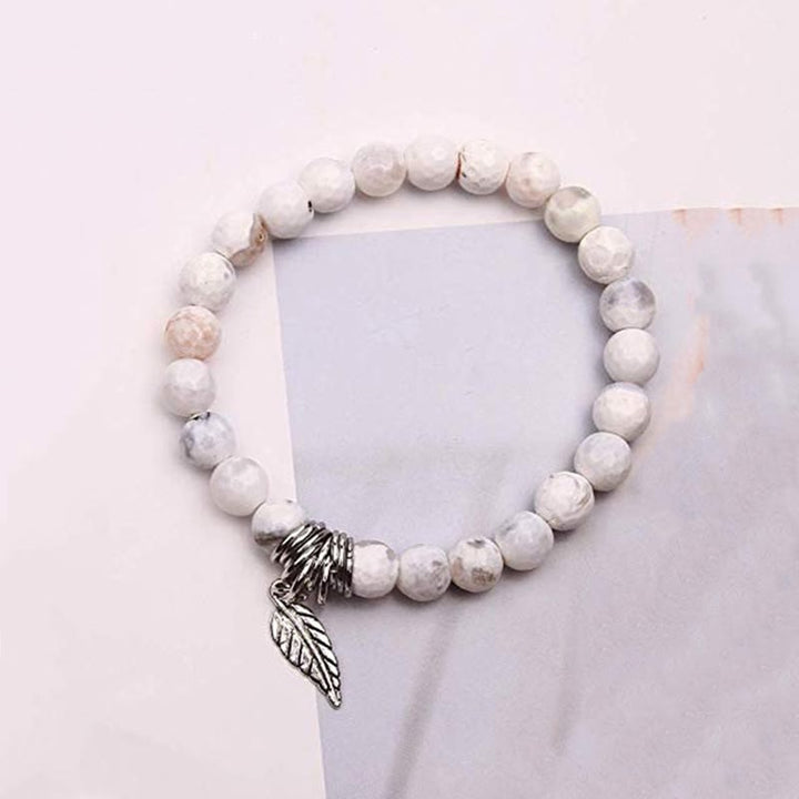 Weißes Naturstein Armband mit Silber Flügel Charm Anhänger elastisch