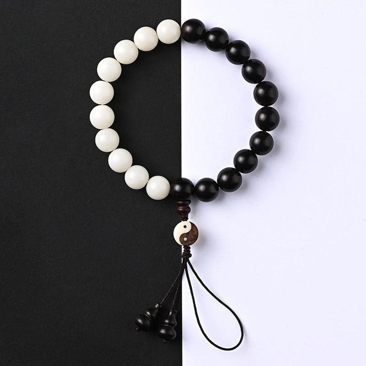 Armband Ebenholz Schutz Yin Yang weiß schwarz Perlen Quaste