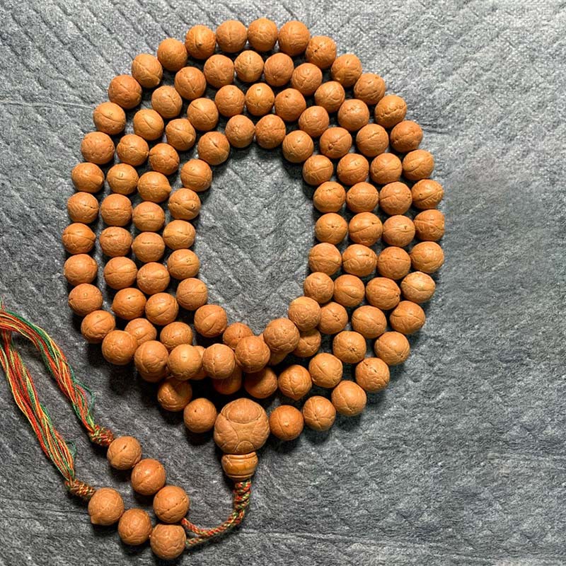 Mala Bodhi Glück Wohlstand Balance Holzkugeln Schnur Grau Untergrund