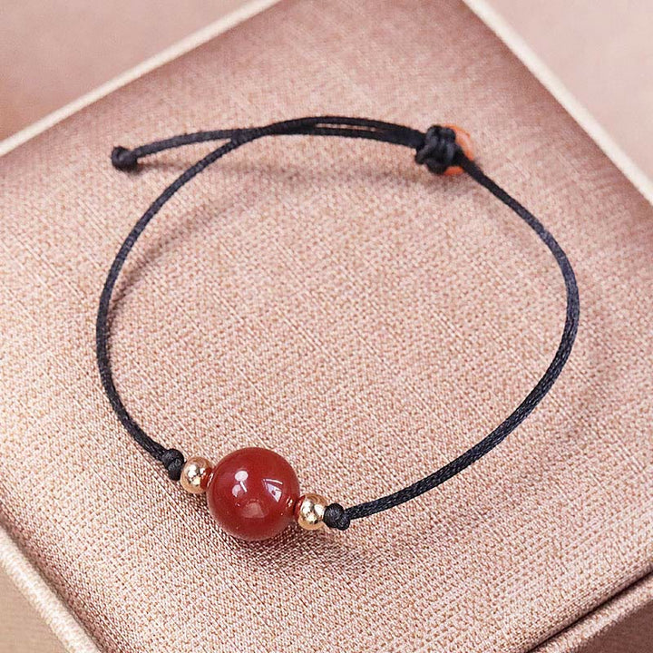 Armband Roter Achat – Balance mit schwarzem Seidenband getragen