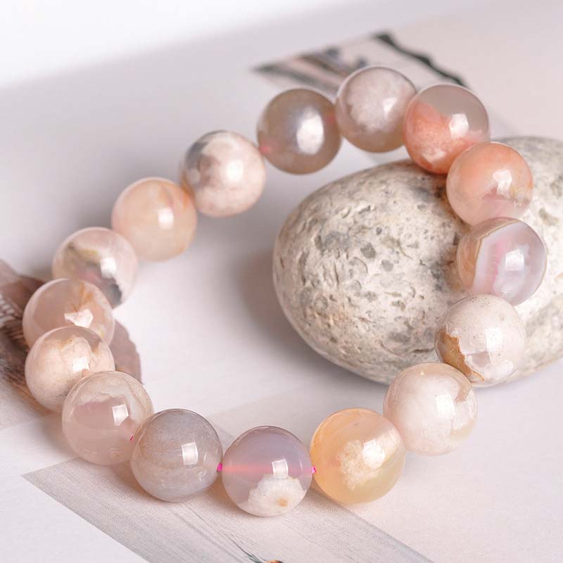 Achat Armband Frieden & Segen Rosa Perlen Naturstein auf Stein Flat Lay