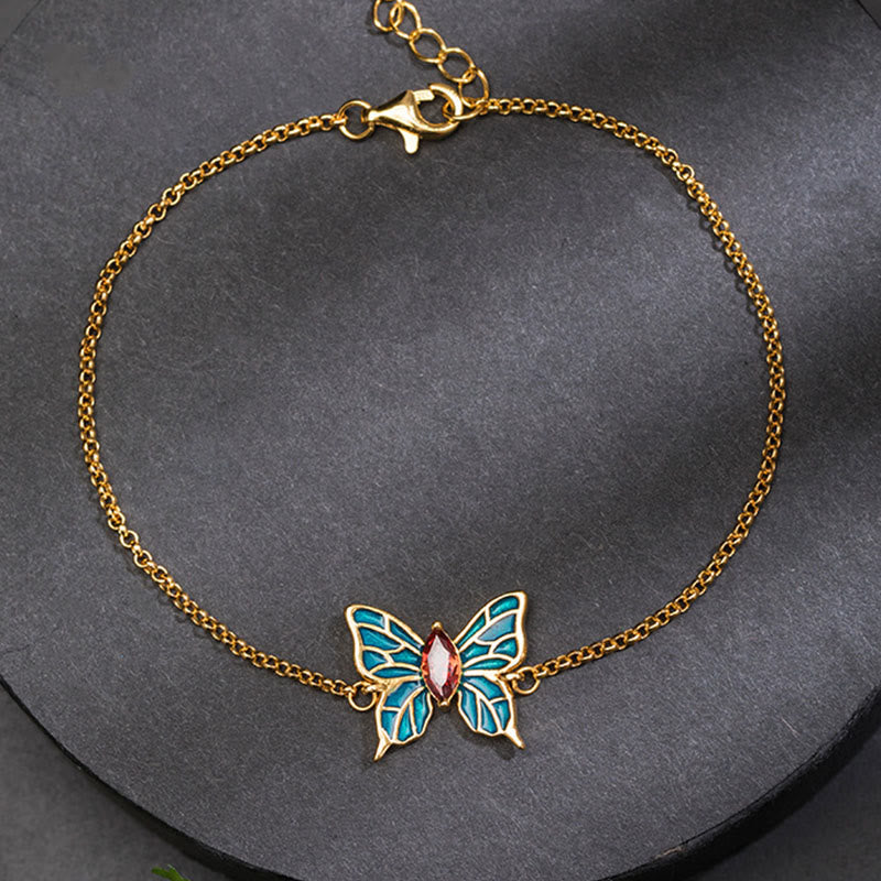 Goldenes Schmetterling Armband mit türkisen Flügeln und rosa Stein