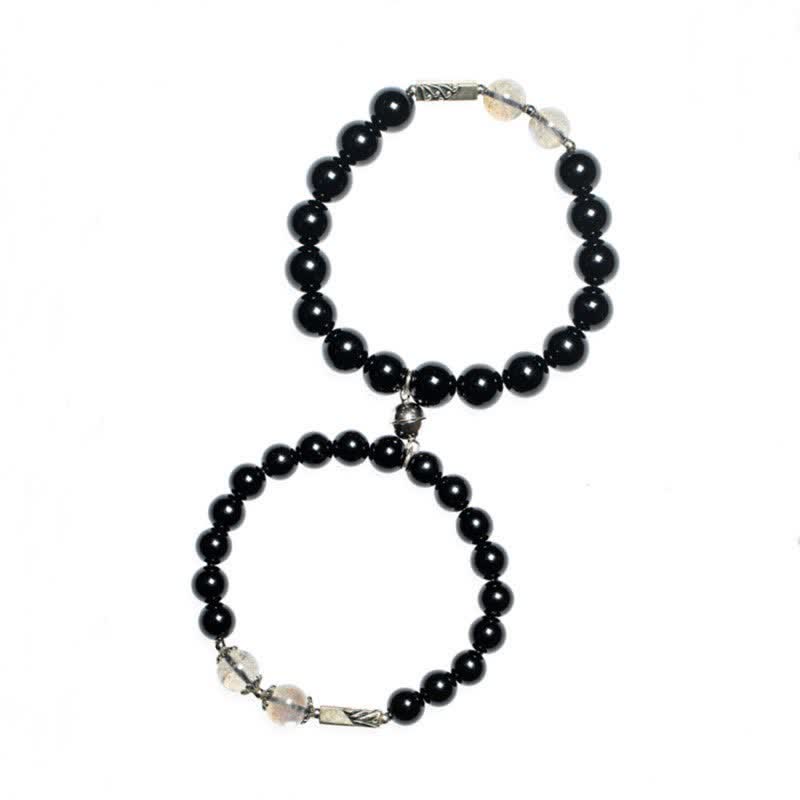 Zwei schwarze Obsidian Armbänder mit Mondstein und Silberverschluss elegant.