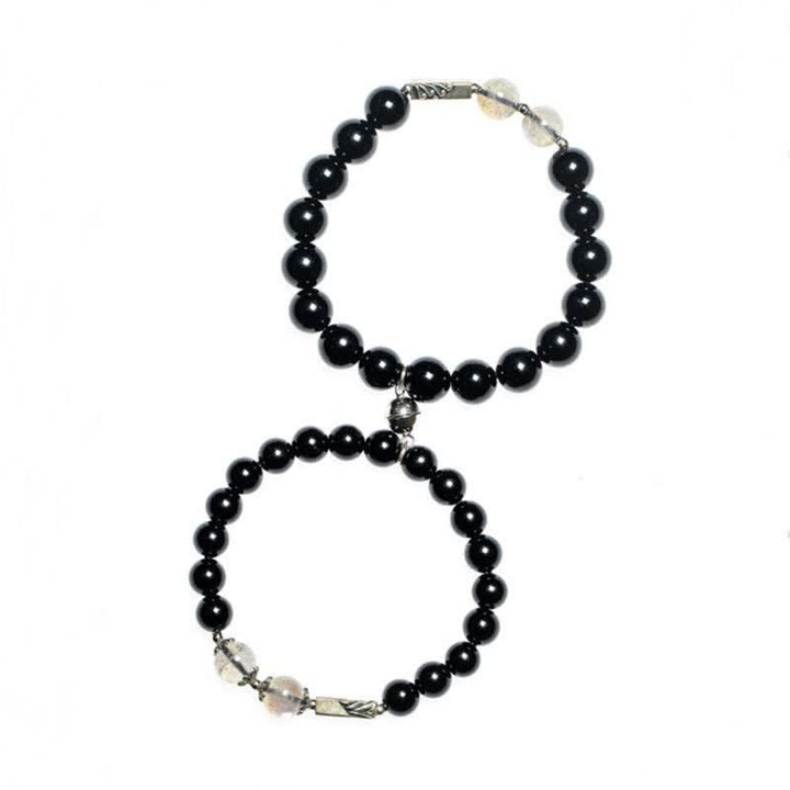 Zwei schwarze Obsidian Armbänder mit Mondstein und Silberverschluss elegant.