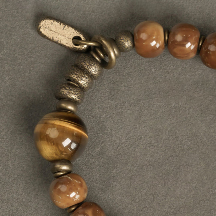 Armband Tigerauge Obsidian mit goldenen Perlen und Verschluss elegant.