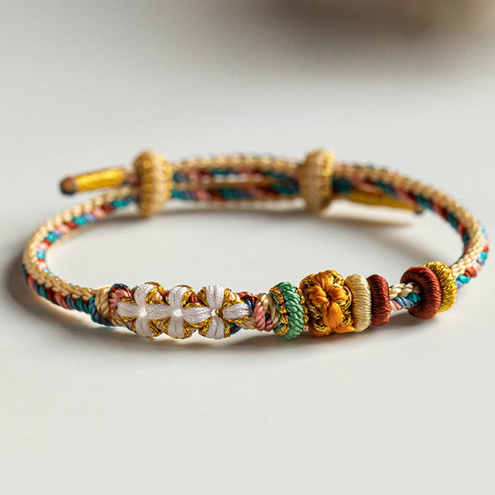 Armband Pfirsichblüte mit bunten Perlen und Quasten elastisch.