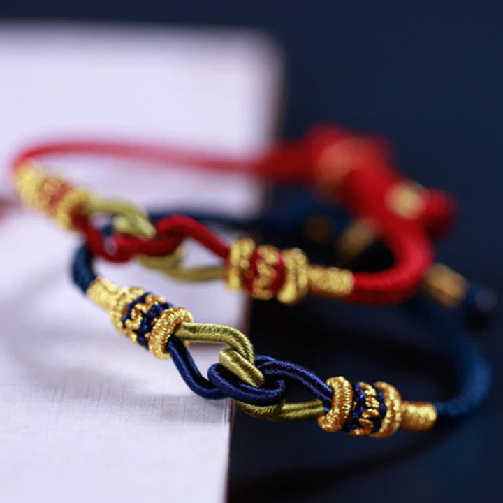Geflochtene Armbänder mit Goldperlen, rote und blaue Knotting Faith Stärke.