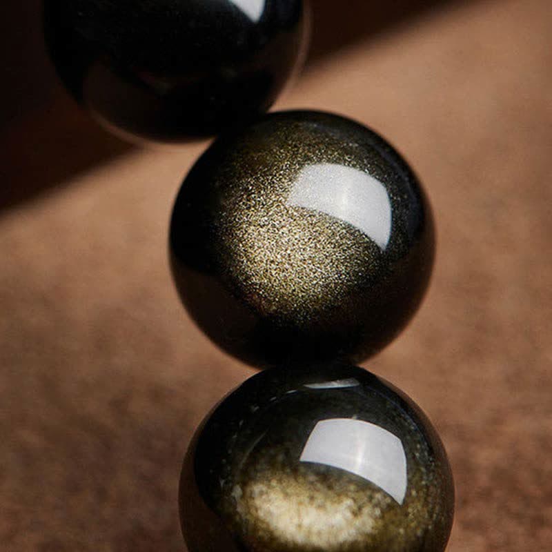 Schwarze Obsidian Perlen Armband mit goldenen Glitzereffekten gestapelt