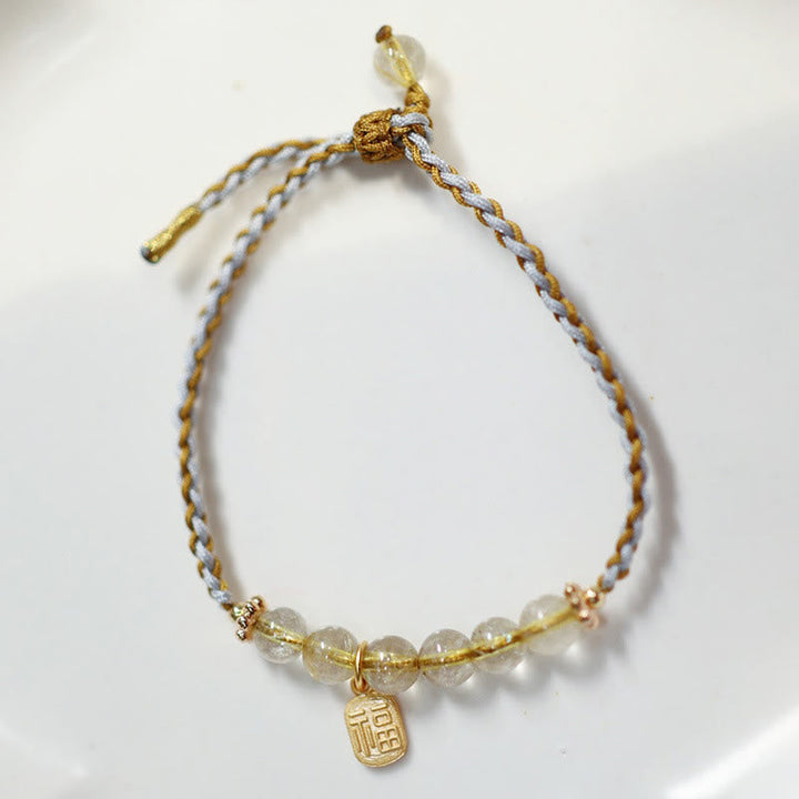 Goldenes Armband mit Jade-Perlen und Fu-Zeichen Anhänger elastisch.