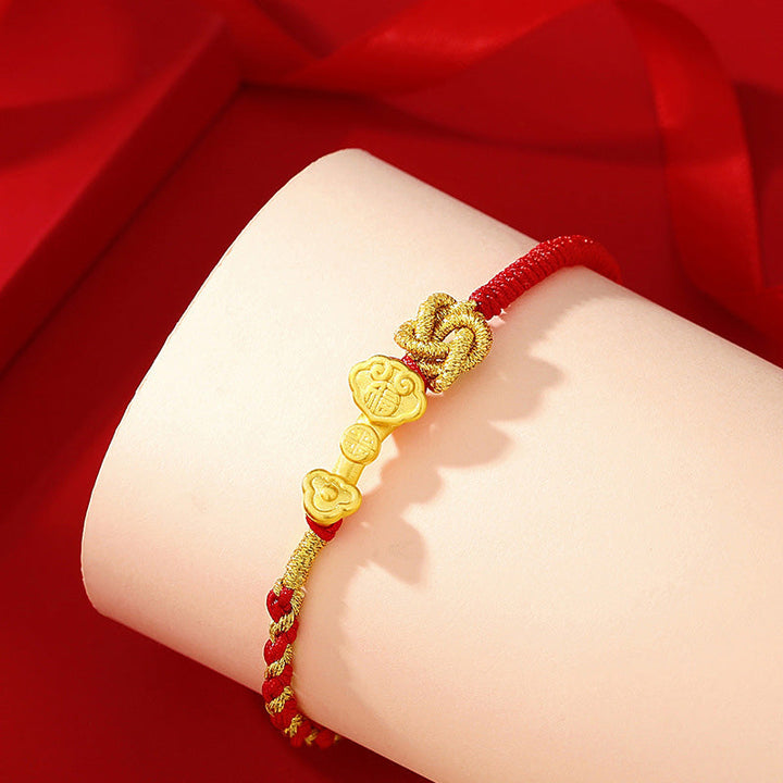 Rotes Armband mit goldenen Fu-Zeichen Anhängern Glück Energie.