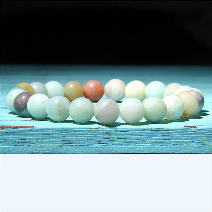 Armband Kristall Achat Balance mehrfarbige Perlen Flachlage Holzuntergrund