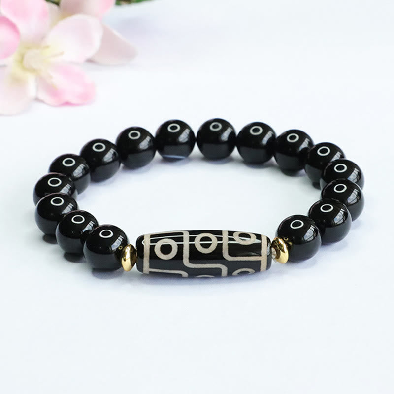 Armband Schwarzer Onyx mit graviertem Mittelteil und goldenen Akzenten elastisch.