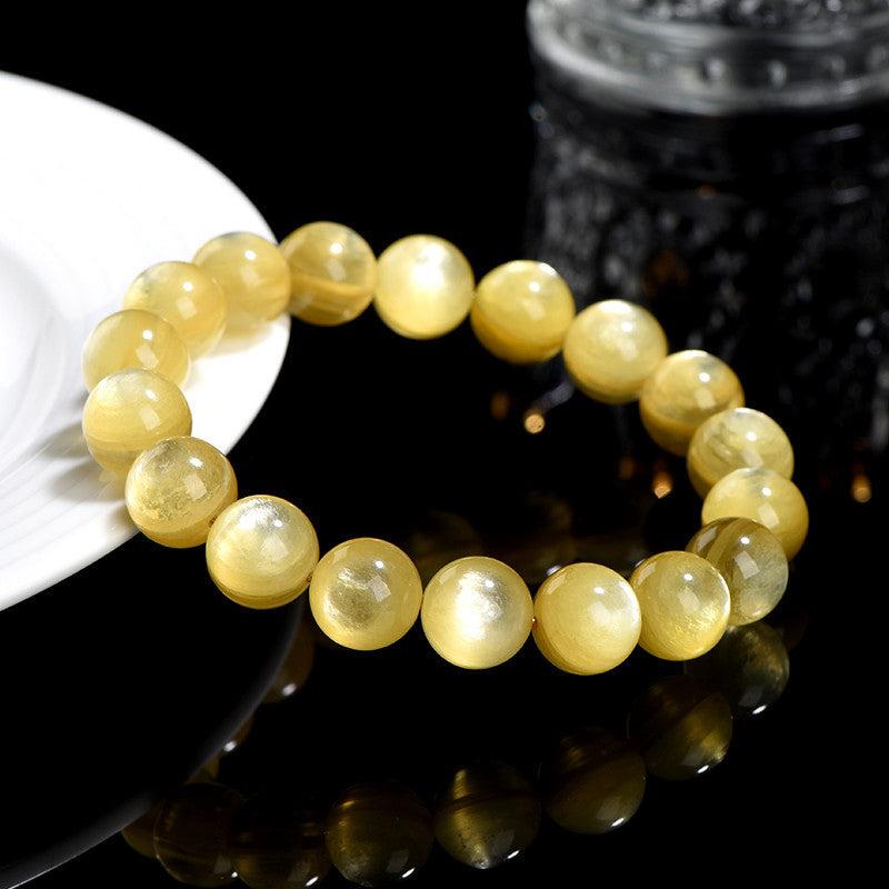 Gelbes Citrin Armband am Handgelenk getragen Schutz Wohlstand Harmonie Naturstein