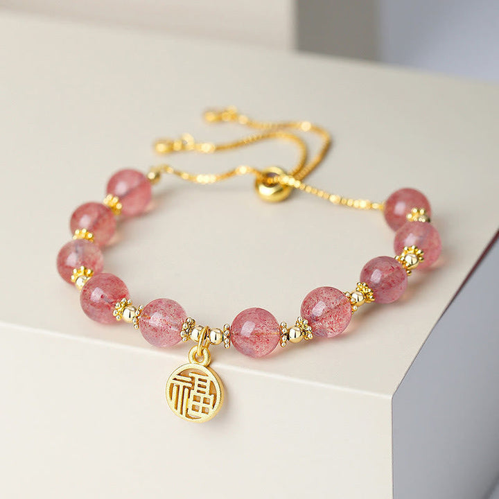 Armband Erdbeerquarz Fu-Zeichen Energie goldfarben Perlen elegant gestylt