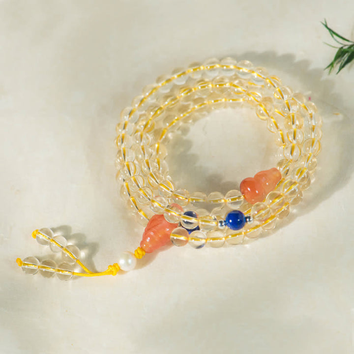 Citrin Mala Armband mit orangefarbenen Perlen und blauen Steinen elegant.