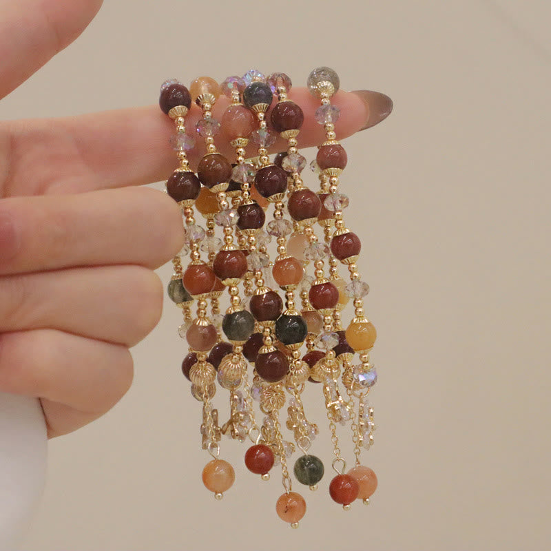 Armband Kristall mit braunen Steinen und goldenen Perlen elegant.
