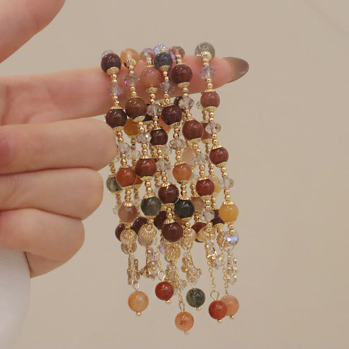 Armband Kristall mit braunen Steinen und goldenen Perlen elegant.