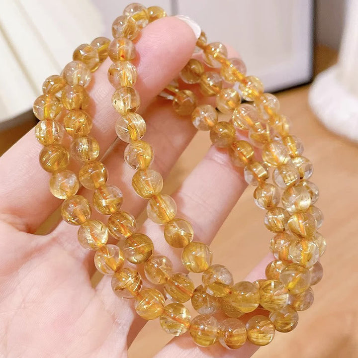 Citrin Armband – Wohlstand & Stärke, facettierte goldene Perlen elastisch getragen