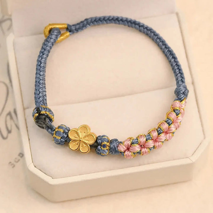 Armband Pfirsichblüte Wohlstand mit goldfarbenen Blüten und grauem Seil