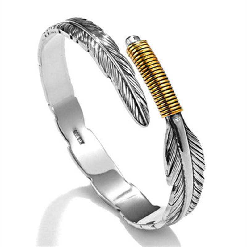 Silbernes Armband mit Feder-Design und goldenem Akzent elegant.