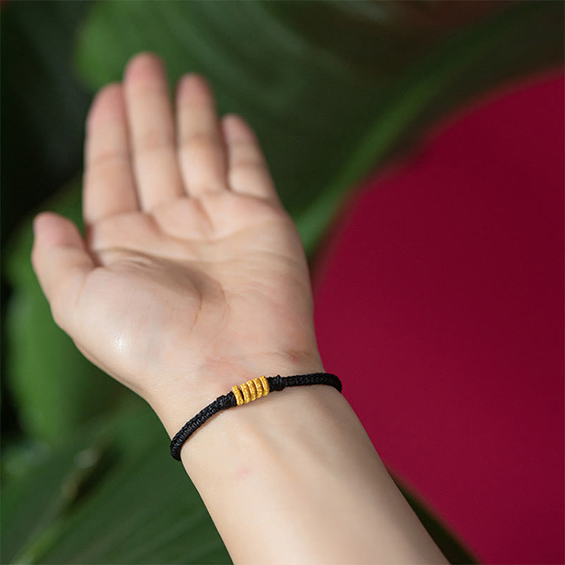 Armband – Schutz & Glück Energie schwarzes Seil goldene Perlen Handgelenk