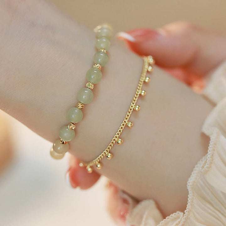 Jade Armband Glück Wohlstand grüne Steine goldene Perlen elegant Handgelenk