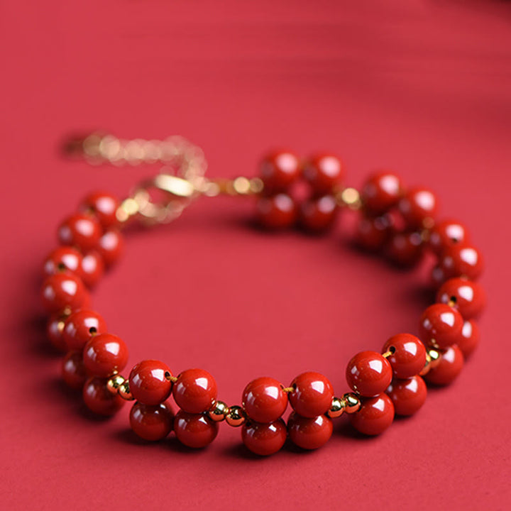 Armband Zinnober – Segen Harmonie rote Perlen goldene Akzente elastisch