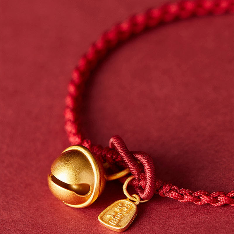 Armband Fu-Zeichen – Glück mit goldenem Glöckchen rotes Seidenband.