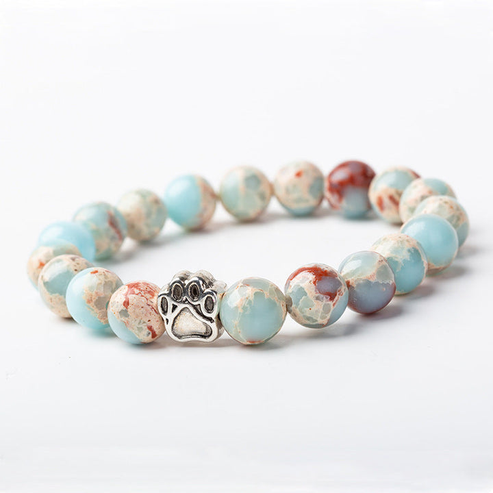 Armband Achat – Ruhe mit hellblauen Natursteinen und Pfötchen-Charm.