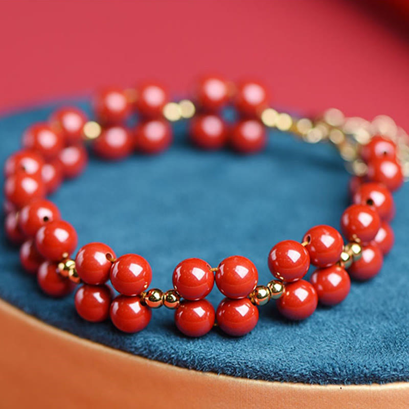 Armband Zinnober – Segen Harmonie rote Perlen Goldakzente elegant
