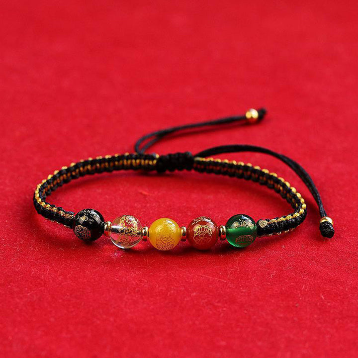 Armband Achat mit fünf Perlen elastisch schwarzes Textilband Schutz